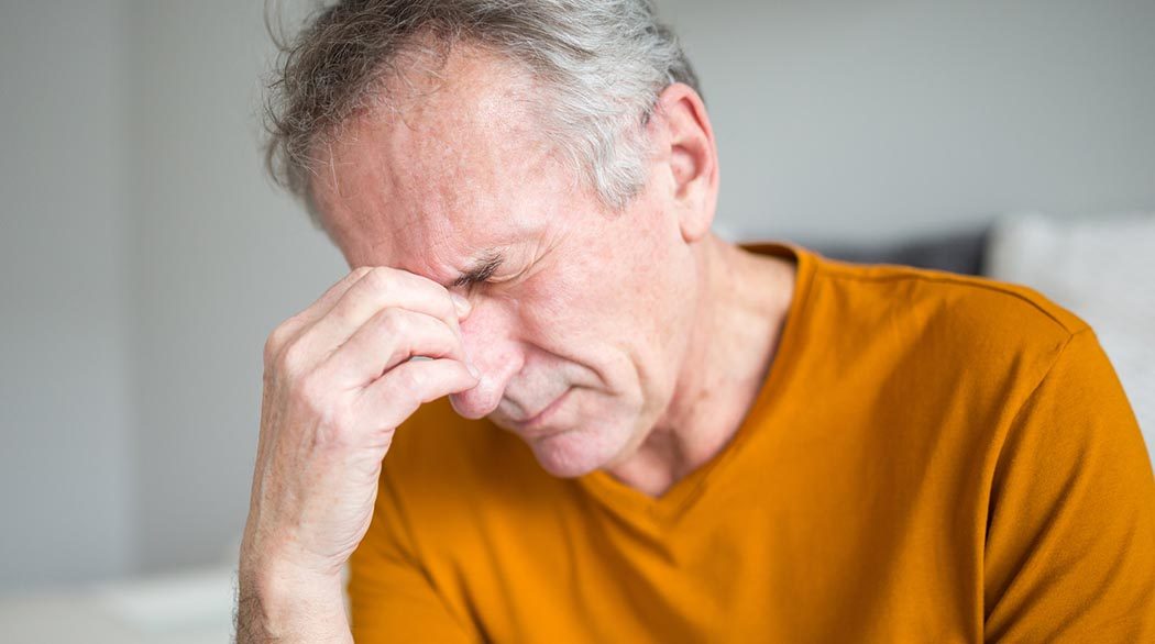 man experiencing headache