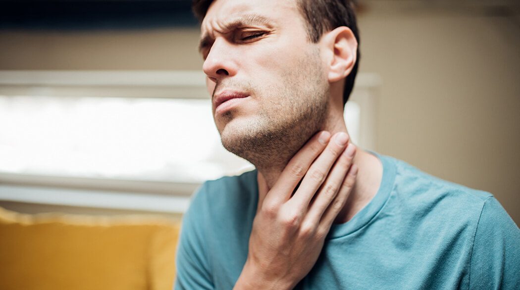 man with sore throat